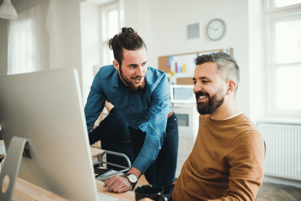 Two men working in the office moving their microsoft business to Pax8 easily