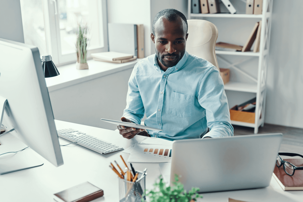 Black man working at his computer assessing his security strategy