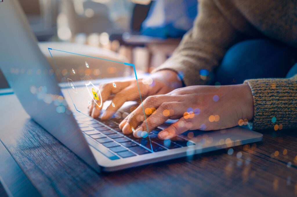 hands typing on keyboard with colored lights above representing a secure protected online website experience