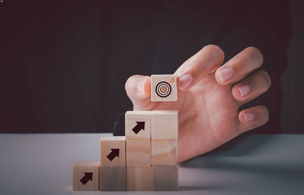 stacked blocks with arrows leading up to target