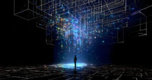 Silhouette of a man standing in a blue spotlight of circuitry