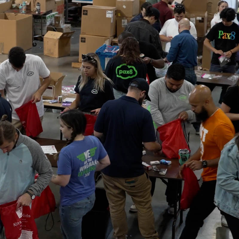 Pax8 employees packing supplies for a charity event for kids