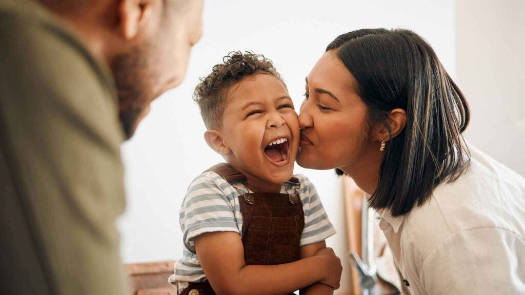 Parents playing with child - showcasing how Pax8 helped Hopes Promise roll out an Azure migration with Anchor Network Solutions