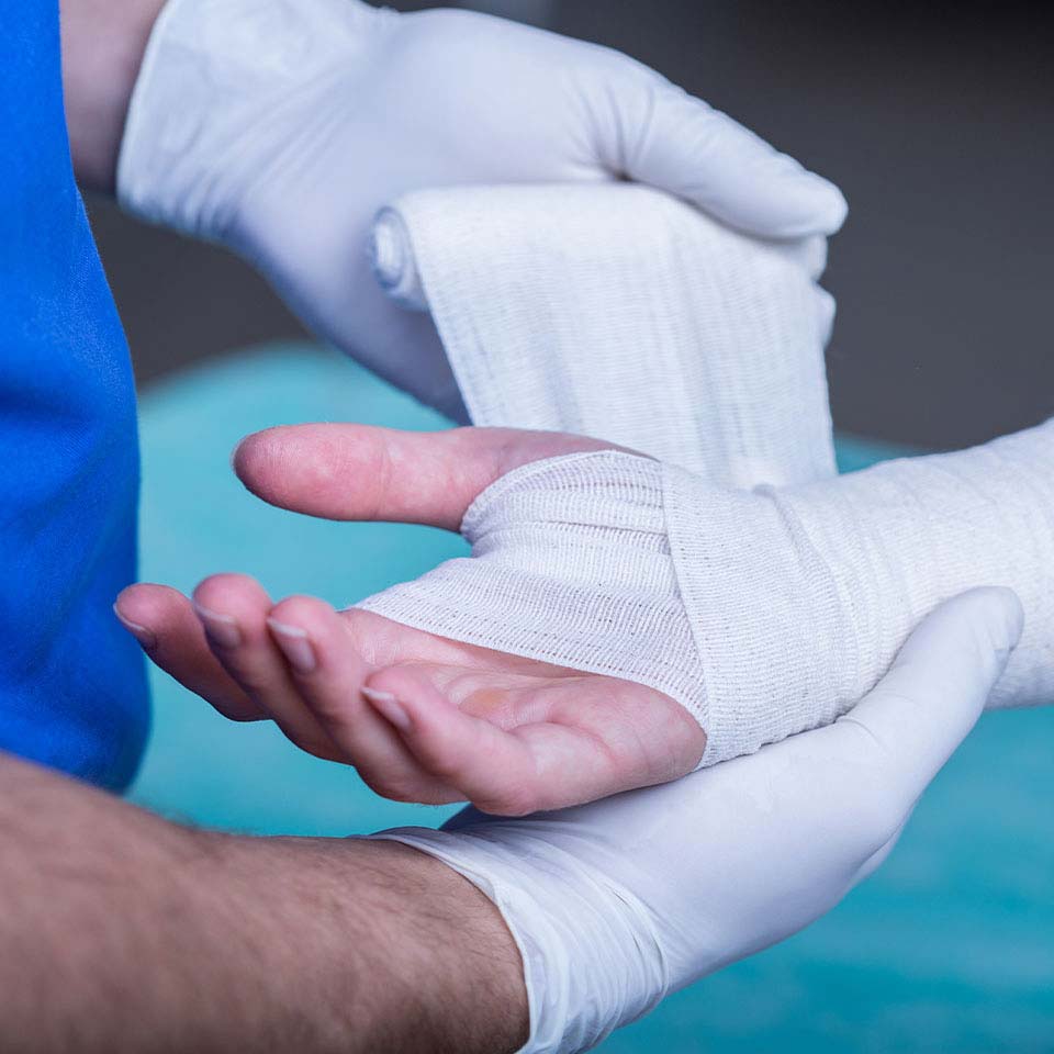 Doctor wrapping an injured hand - representing how Nexustek helped a client migrate to M365 in just 2 weeks