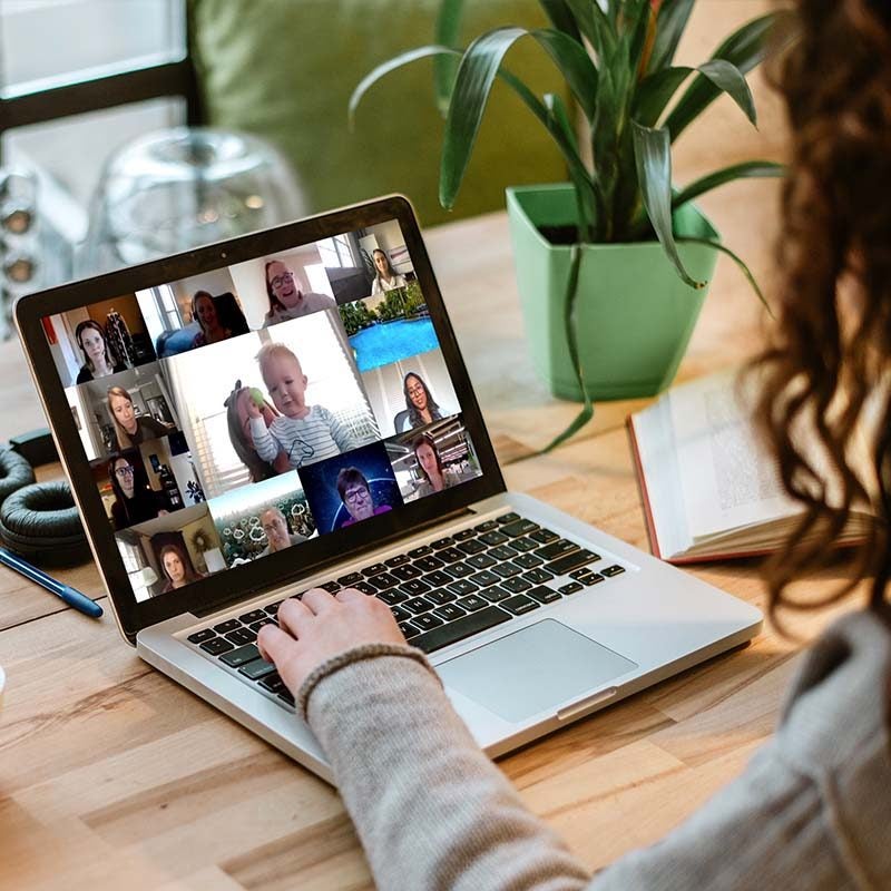 woman on laptop in online meeting with coworkers