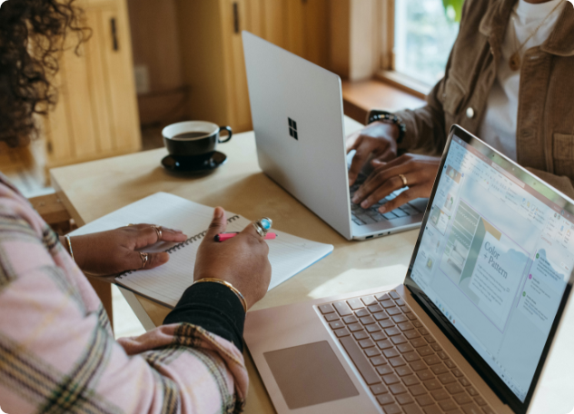 Person using laptop and notebook